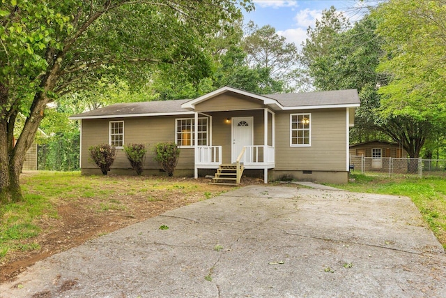 ranch-style house featuring fence, covered porch, and crawl space