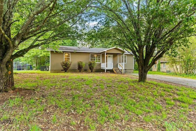 ranch-style home with a porch, a front lawn, and crawl space