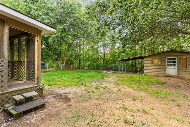 view of yard featuring fence and a sunroom