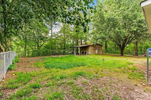 view of yard with an outdoor structure and a fenced backyard