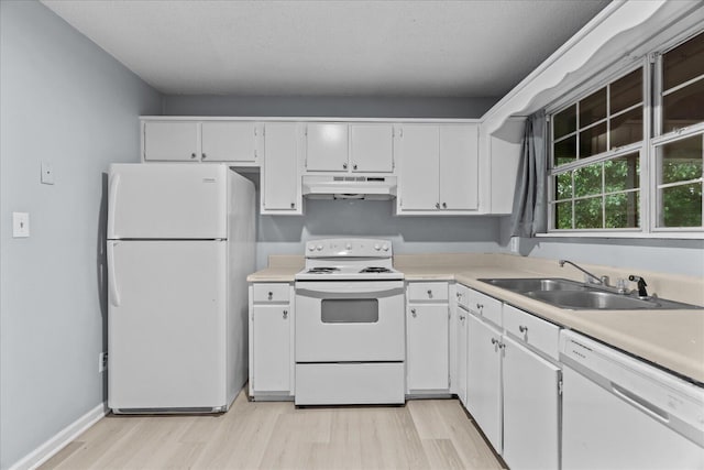 kitchen with a sink, white appliances, light wood-style flooring, white cabinetry, and under cabinet range hood