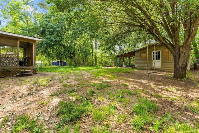 view of yard featuring a sunroom and fence
