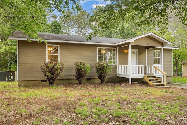 view of front facade with a porch, central AC unit, and crawl space