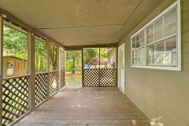wooden terrace with an outbuilding