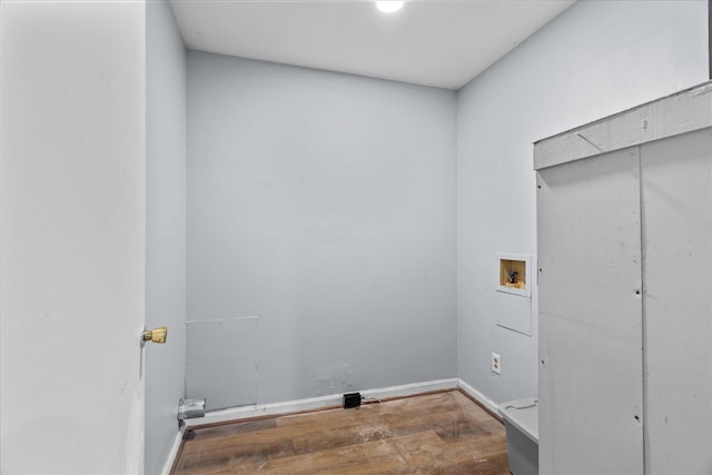 laundry area with washer hookup, baseboards, laundry area, and wood finished floors