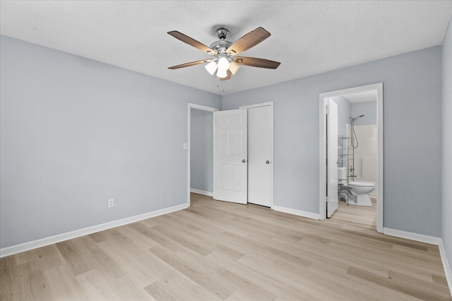 unfurnished bedroom with baseboards, ceiling fan, light wood finished floors, and ensuite bath