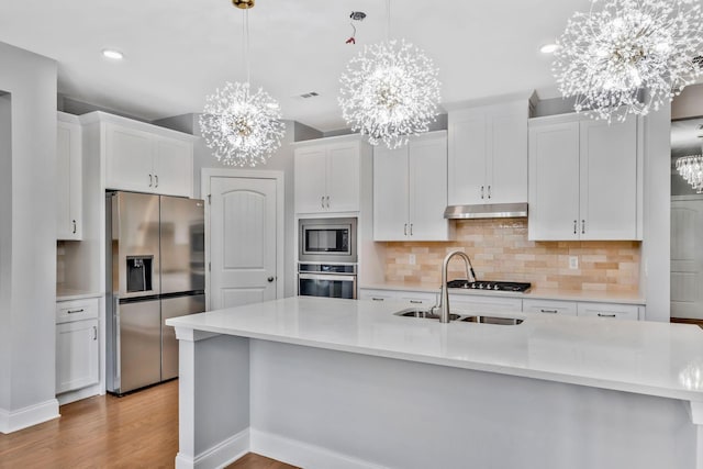 4284 Stone Hall Blvd, Hermitage, TN 37076 - kitchen with appliances with stainless steel finishes, tasteful backsplash, a sink, a chandelier, and white cabinetry