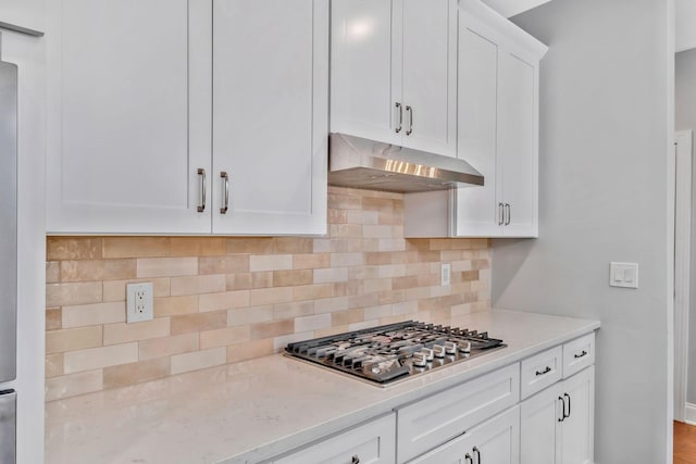 4284 Stone Hall Blvd, Hermitage, TN 37076 - kitchen with light stone counters, stainless steel gas cooktop, white cabinetry, tasteful backsplash, and under cabinet range hood