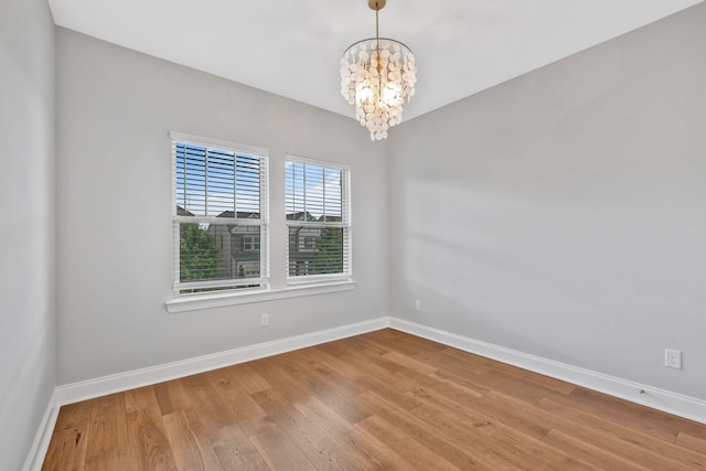 4284 Stone Hall Blvd, Hermitage, TN 37076 - unfurnished room with baseboards, a chandelier, and wood finished floors