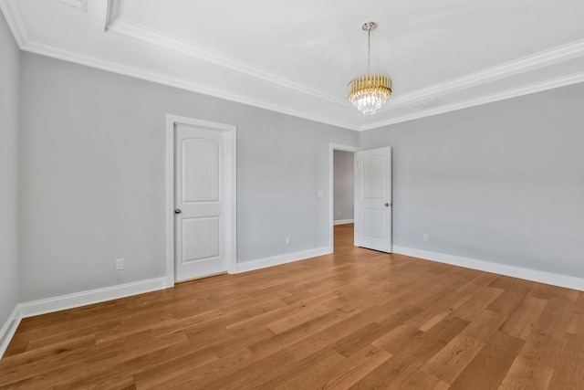 4284 Stone Hall Blvd, Hermitage, TN 37076 - empty room with light wood-style floors, crown molding, a raised ceiling, baseboards, and an inviting chandelier
