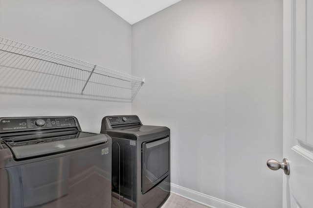4284 Stone Hall Blvd, Hermitage, TN 37076 - clothes washing area featuring independent washer and dryer, light tile patterned flooring, laundry area, and baseboards