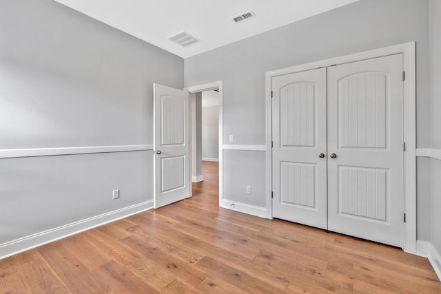 4284 Stone Hall Blvd, Hermitage, TN 37076 - unfurnished bedroom featuring baseboards, a closet, wood finished floors, and visible vents