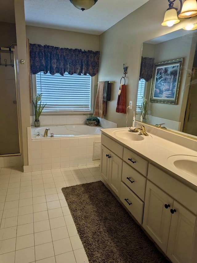 bathroom featuring a sink, tile patterned flooring, double vanity, a shower stall, and a bath