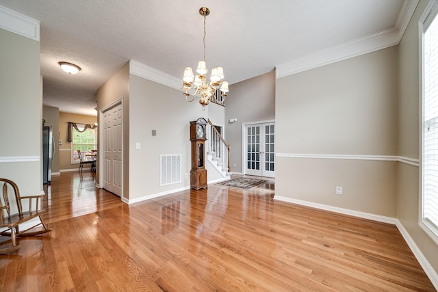 116 N Wynridge Way, Goodlettsville, TN 37072 - unfurnished room with light wood finished floors, a chandelier, baseboards, stairs, and crown molding