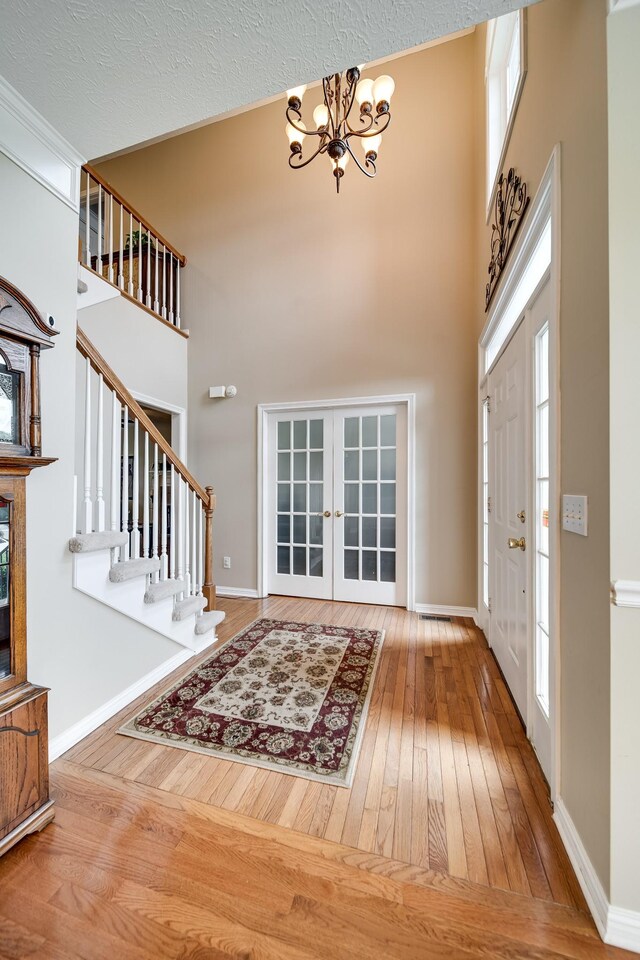 116 N Wynridge Way, Goodlettsville, TN 37072 - entrance foyer featuring hardwood / wood-style flooring, a chandelier, a towering ceiling, french doors, and baseboards