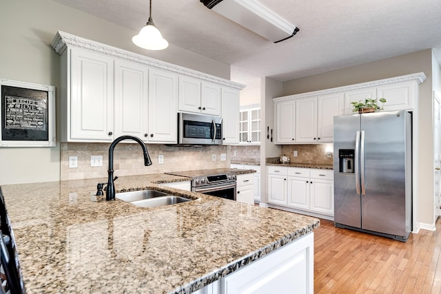 116 N Wynridge Way, Goodlettsville, TN 37072 - kitchen with stainless steel appliances, a sink, light stone countertops, white cabinets, and a textured ceiling