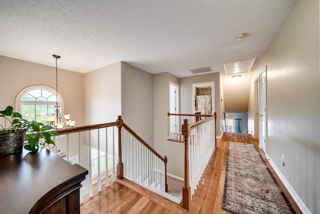 116 N Wynridge Way, Goodlettsville, TN 37072 - hall with an upstairs landing, light wood-style flooring, a textured ceiling, a chandelier, and attic access