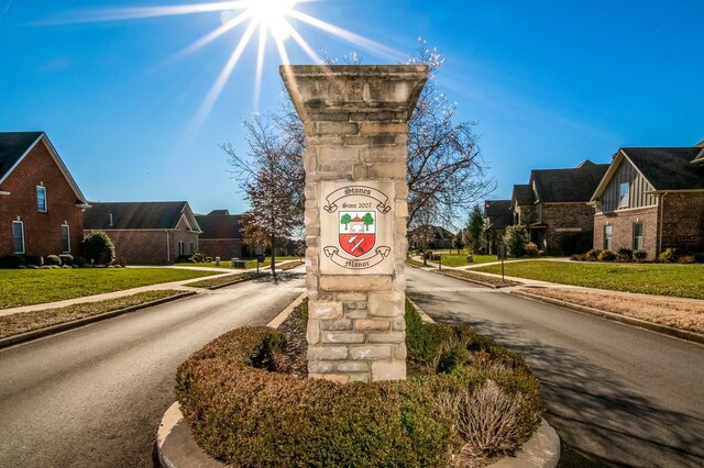 view of road with a residential view, sidewalks, and curbs