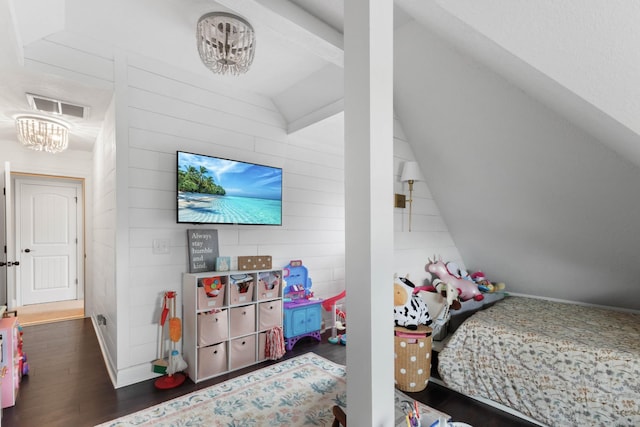 bedroom with a chandelier, wood walls, wood finished floors, vaulted ceiling, and visible vents
