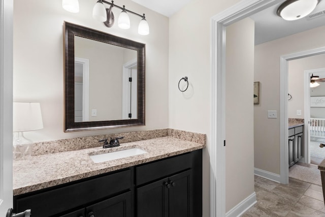 bathroom featuring baseboards, visible vents, and vanity
