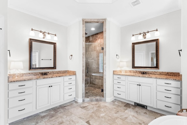 bathroom featuring crown molding, a stall shower, a sink, and visible vents