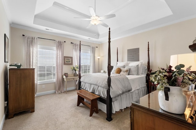 bedroom with light colored carpet, visible vents, ornamental molding, and a raised ceiling