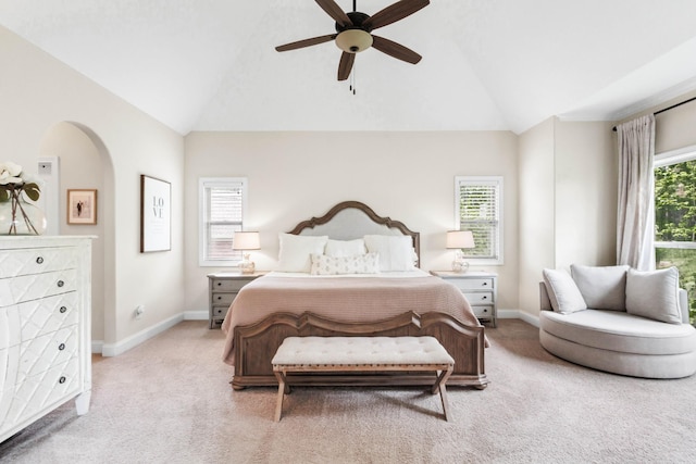 bedroom featuring baseboards, vaulted ceiling, and light carpet