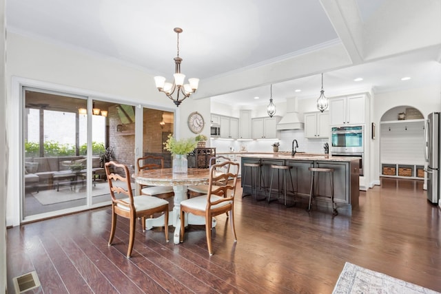 dining area featuring crown molding, a chandelier, recessed lighting, visible vents, and dark wood-style floors