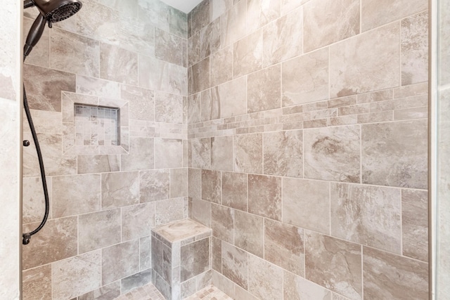 full bathroom featuring tiled shower