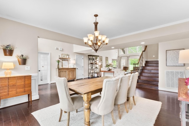 dining area featuring visible vents, crown molding, stairway, dark wood-style floors, and a chandelier