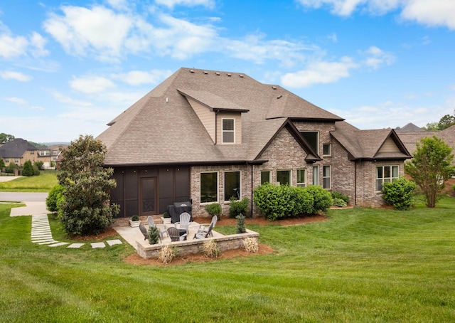 back of house with brick siding, a shingled roof, a patio area, and a yard