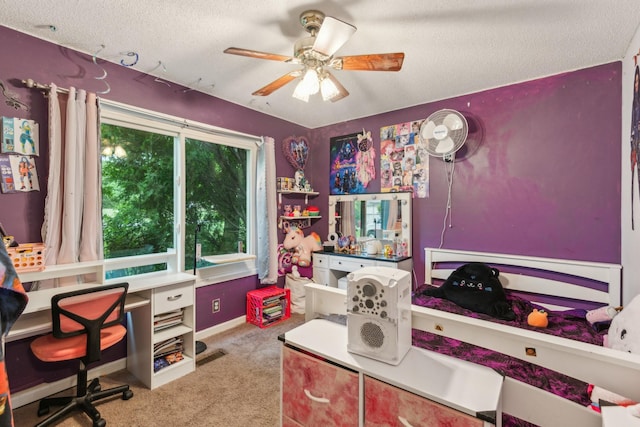 office area featuring a ceiling fan, carpet flooring, and a textured ceiling