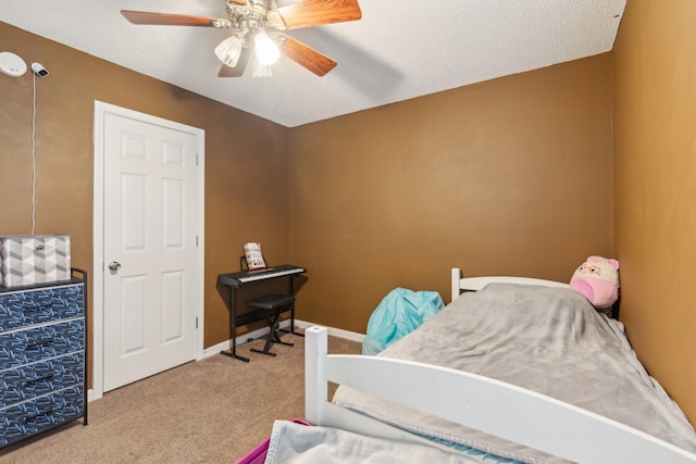 carpeted bedroom with baseboards and ceiling fan