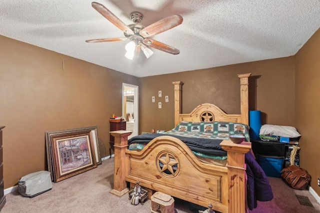 bedroom with ceiling fan, carpet, and a textured ceiling
