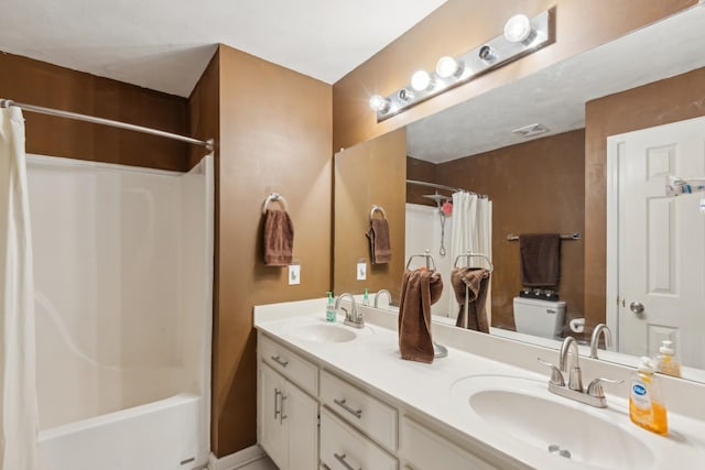 full bath featuring double vanity, toilet, visible vents, and a sink