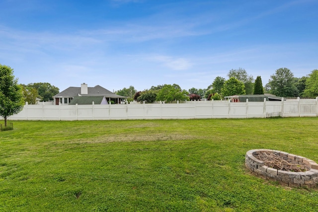 view of yard with a fire pit