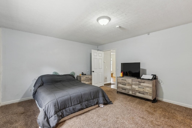 carpeted bedroom with baseboards and a textured ceiling