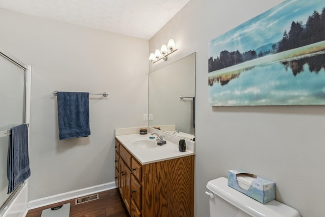 full bath featuring visible vents, vanity, wood finished floors, toilet, and baseboards
