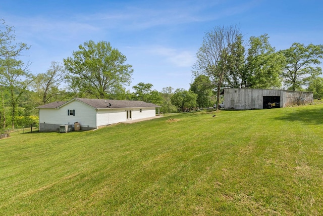 view of yard featuring an outbuilding, a pole building, and cooling unit