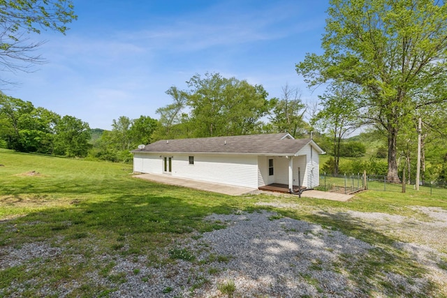 exterior space with a patio area, fence, and a yard