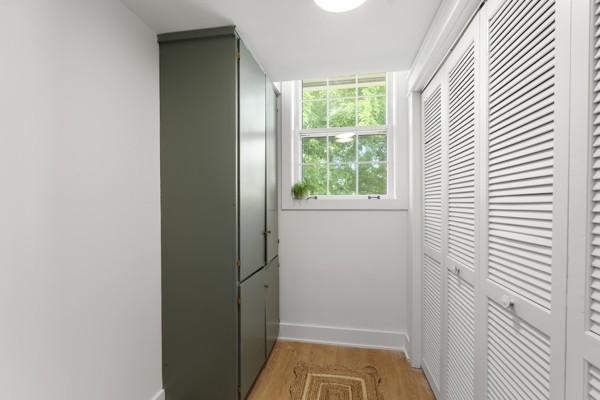 doorway featuring baseboards and light wood-type flooring