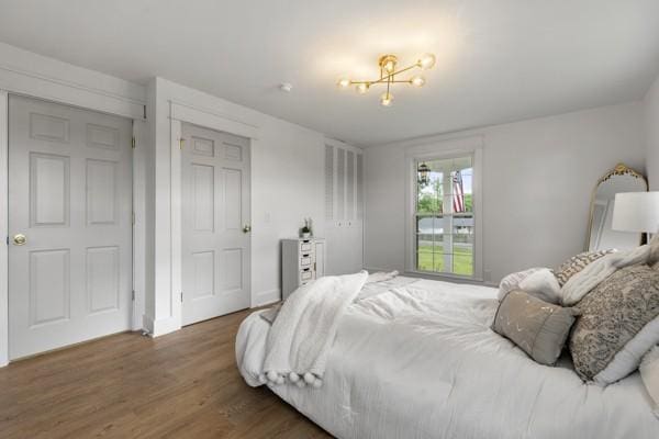 bedroom with baseboards and wood finished floors