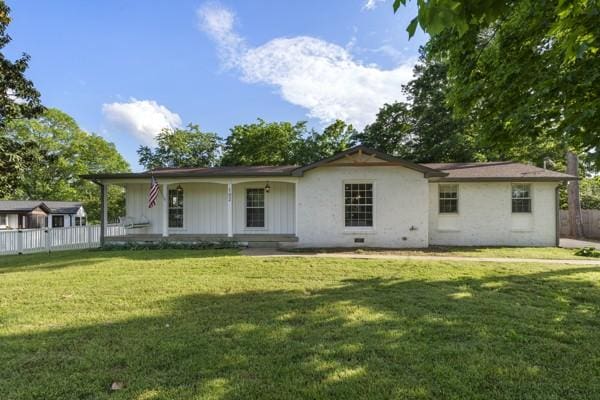 back of property with fence and a yard