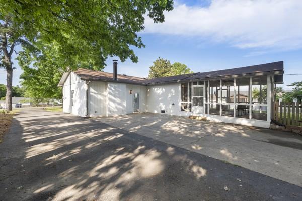 back of property with a sunroom