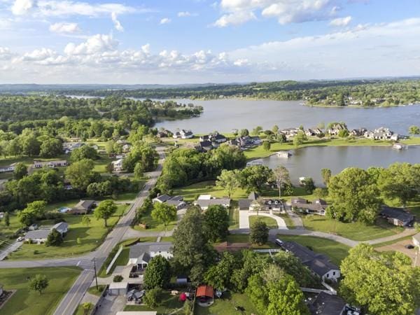 drone / aerial view featuring a water view and a residential view