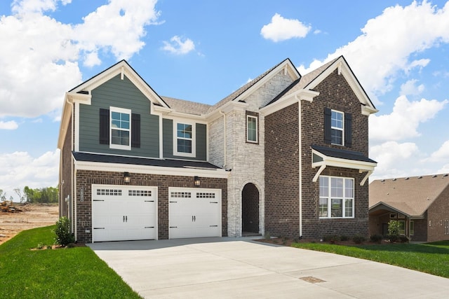view of front of property featuring a garage, driveway, and brick siding