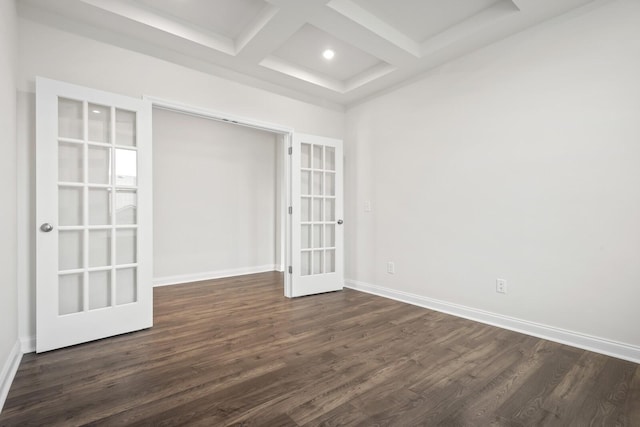 empty room with beam ceiling, baseboards, dark wood-type flooring, french doors, and coffered ceiling