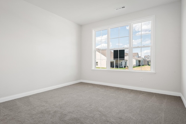 carpeted empty room with baseboards and visible vents