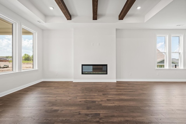 unfurnished living room featuring a glass covered fireplace, baseboards, beamed ceiling, and dark wood-style flooring