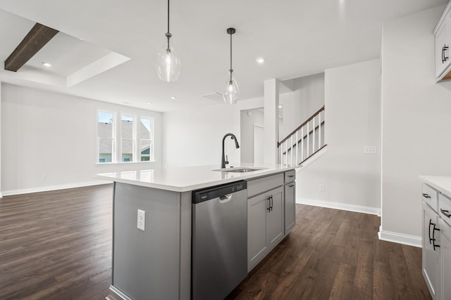 kitchen with a sink, light countertops, stainless steel dishwasher, and dark wood-type flooring